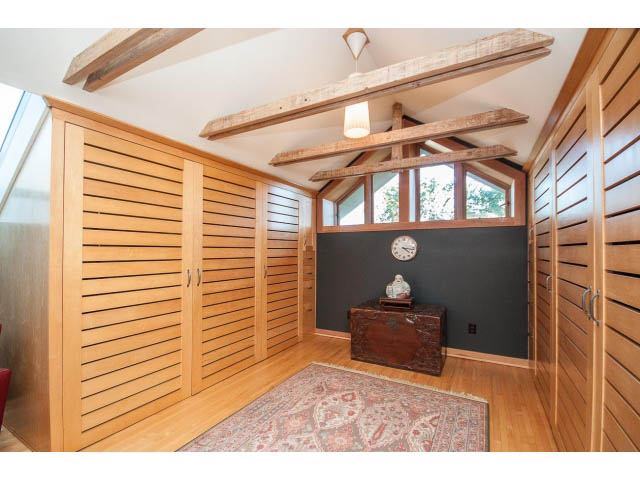 Furnished living room with wooden slats, hardwood floors, and a cozy rug. - 1015 West 16th Ave, Vancouver West Side