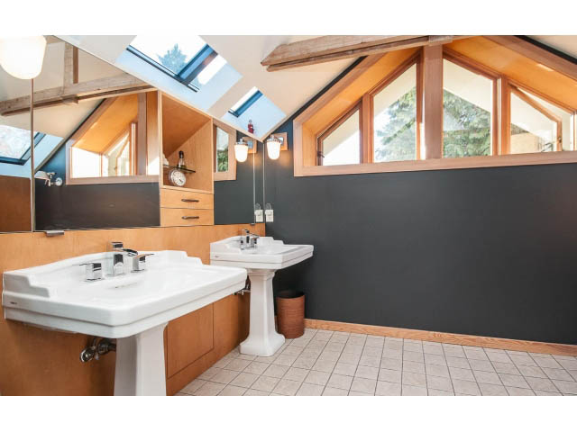 Bright bathroom with skylights and dark walls, modern sink and mirror. - 1015 West 16th Ave, Vancouver West Side