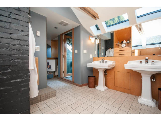 Spacious bathroom with modern sink, large mirror, and natural light from skylights. - 1015 West 16th Ave, Vancouver West Side
