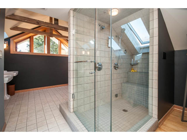 Spacious bathroom with large glass shower and wooden beams. - 1015 West 16th Ave, Vancouver West Side