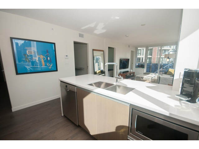 Bright kitchen with white countertops, hardwood floors, and a city view. - 805 - 1009 Harwood Street, Vancouver Downtown