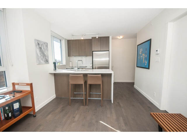 Bright kitchen with modern cabinetry, hardwood floors, and a city view. - 805 - 1009 Harwood Street, Vancouver Downtown