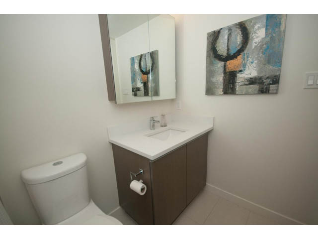 Bright bathroom with modern sink, countertop, and abstract wall art. - 805 - 1009 Harwood Street, Vancouver Downtown