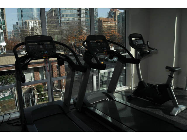 Bright fitness room with treadmills and city view. - 805 - 1009 Harwood Street, Vancouver Downtown