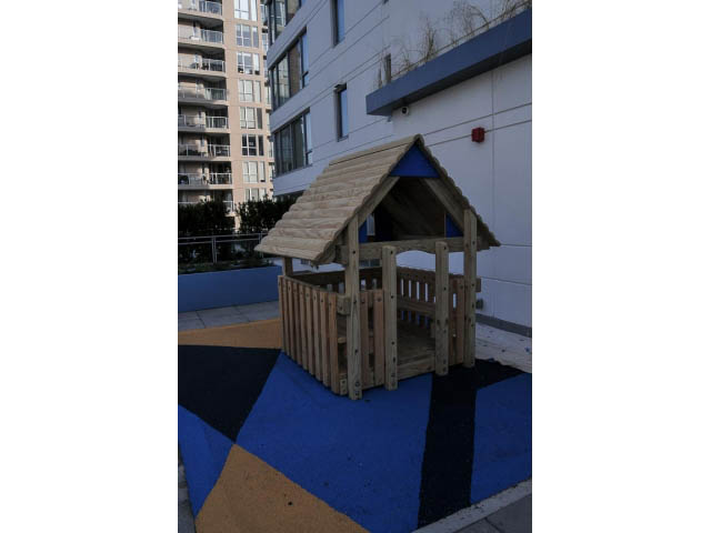 Play area with wooden playhouse and blue flooring. - 805 - 1009 Harwood Street, Vancouver Downtown