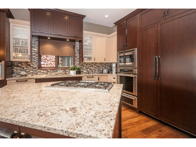 Bright kitchen with granite countertops, hardwood floors, and a modern design. - 3765 Dollarton Hwy, North Vancouver
