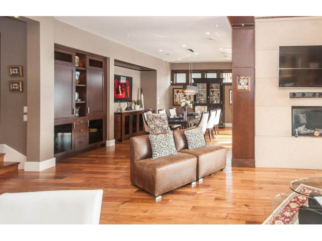 Spacious open-concept living room with hardwood floors and a modern fireplace. - 3765 Dollarton Hwy, North Vancouver