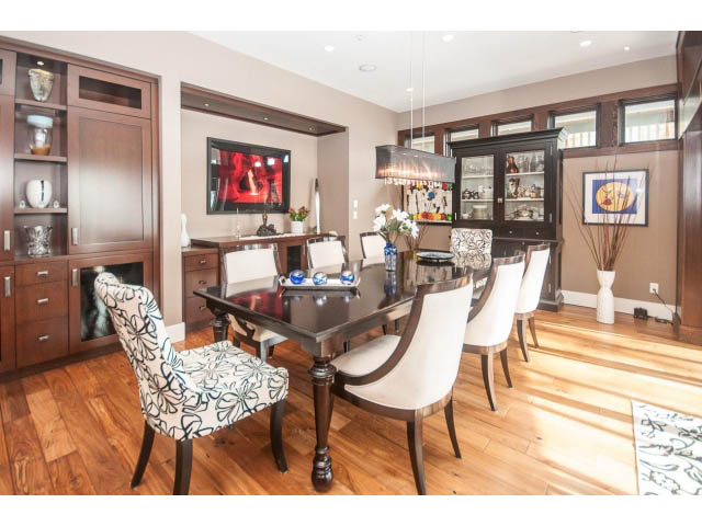 Elegant dining room with hardwood floors, modern chandelier, and built-in cabinets. - 3765 Dollarton Hwy, North Vancouver