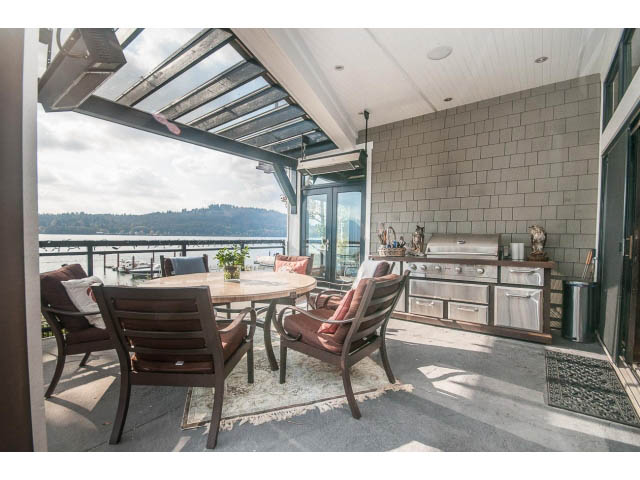 Spacious patio with modern furniture, city view, and gas grill. - 3765 Dollarton Hwy, North Vancouver