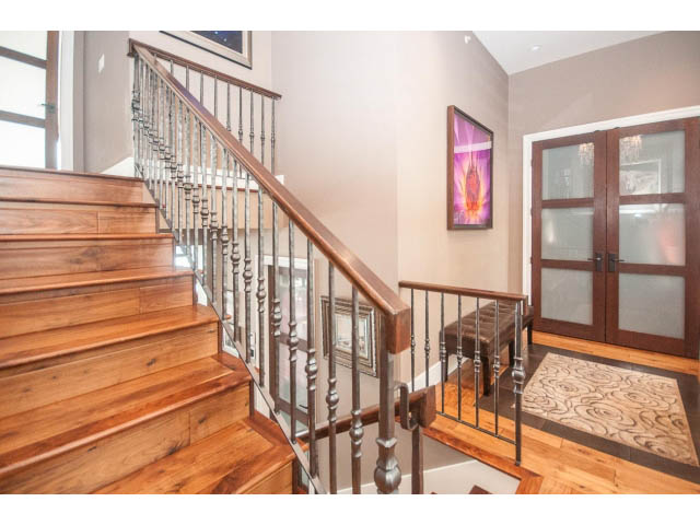 Staircase leading to upper floor with wooden steps and metal railings. - 3765 Dollarton Hwy, North Vancouver