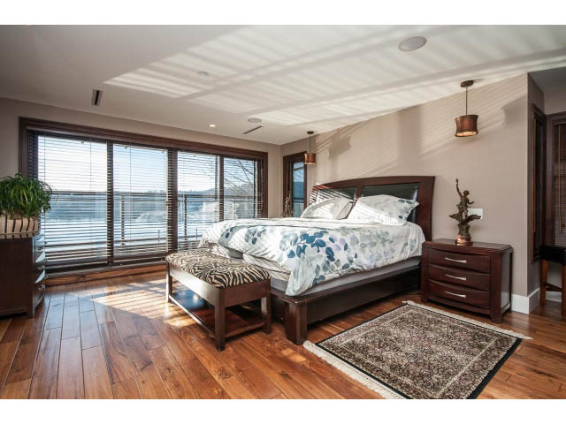 Spacious bedroom with hardwood floors, large windows, and a city view. - 3765 Dollarton Hwy, North Vancouver