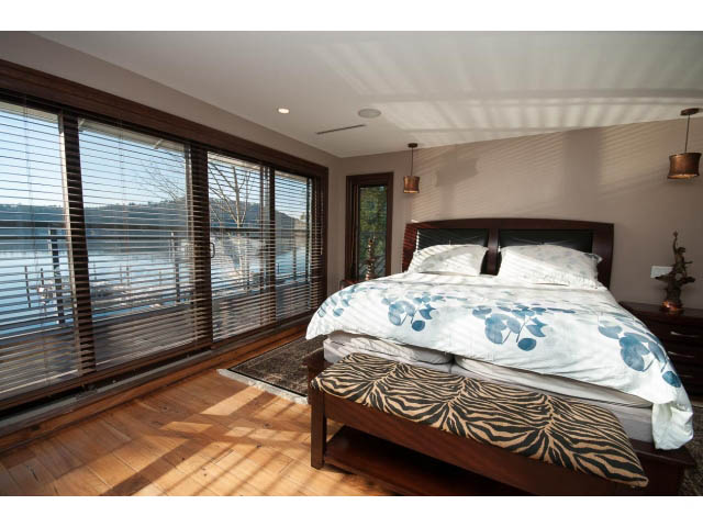 Spacious bedroom with wooden floors, large windows, and a city view. - 3765 Dollarton Hwy, North Vancouver