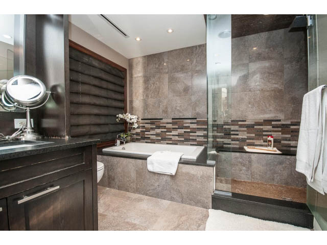 Spacious bathroom with dark wood cabinets, granite countertops, and a walk-in shower. - 3765 Dollarton Hwy, North Vancouver