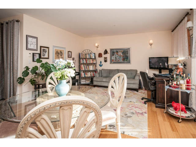 Furnished living room with hardwood floors, glass table, and bookshelf. - 3765 Dollarton Hwy, North Vancouver
