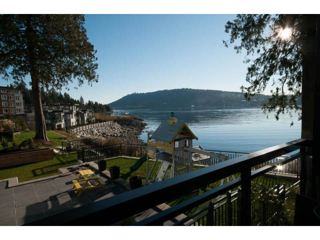 Bright living room with waterfront view and picnic table. - 3765 Dollarton Hwy, North Vancouver