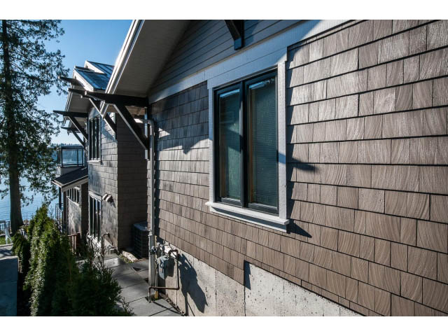 Furnished 5-bedroom house with wooden siding and large windows. - 3765 Dollarton Hwy, North Vancouver