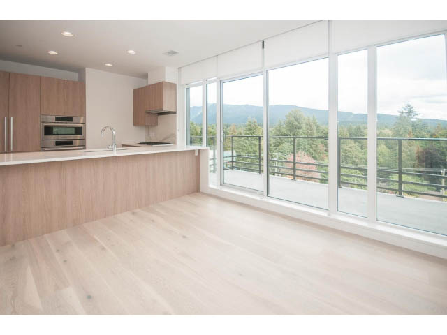 Bright kitchen with hardwood floors and a city view. - 510 - 2738 Library Lane, North Vancouver