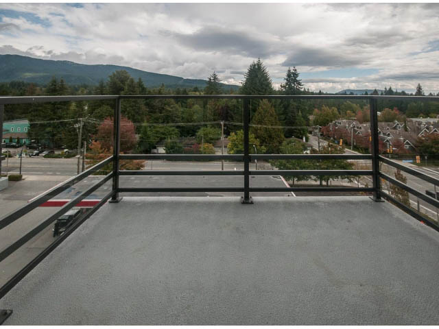Furnished balcony with city view and trees in the background. - 510 - 2738 Library Lane, North Vancouver