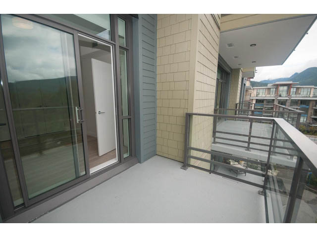 Bright balcony with glass railings, city view, and modern design. - 510 - 2738 Library Lane, North Vancouver