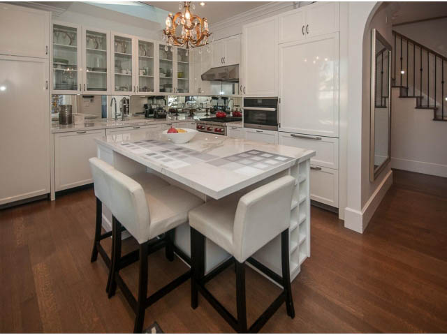 Bright kitchen with white cabinetry, granite countertops, and hardwood floors. - 1973 W 15th Ave, Vancouver West Side