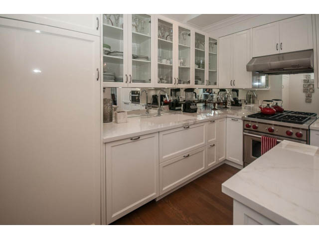 Bright kitchen with white cabinets, marble countertops, and hardwood floors. - 1973 W 15th Ave, Vancouver West Side