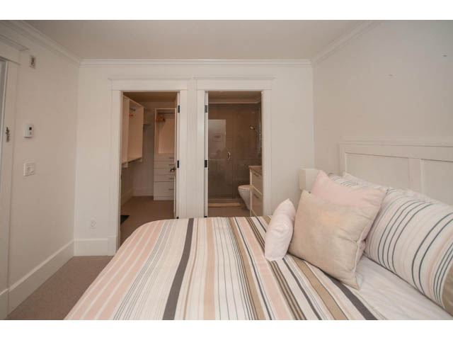 Bright bedroom with striped bedding and built-in closet. - 1973 W 15th Ave, Vancouver West Side