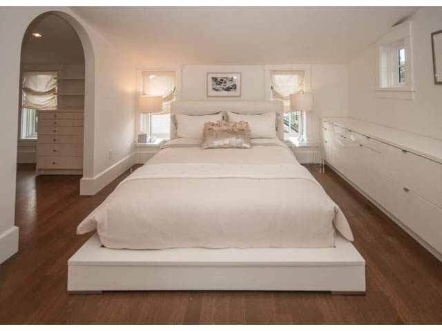 Furnished bedroom with white bedding, hardwood floors, and a large window. - 1973 W 15th Ave, Vancouver West Side