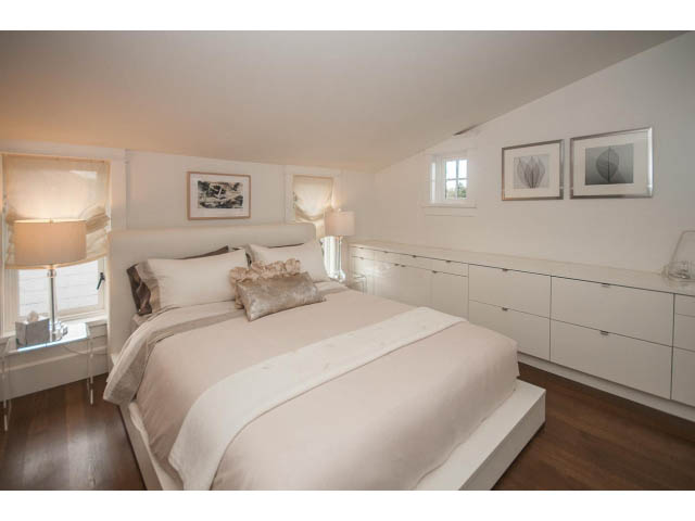 Furnished 3-bedroom bedroom with white walls, hardwood floors, and a cozy bed setup. - 1973 W 15th Ave, Vancouver West Side