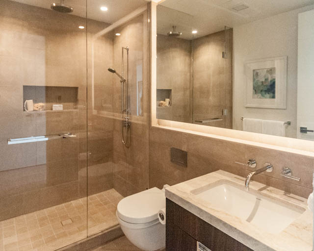 Spacious bathroom with marble countertops and a walk-in shower. - 601 - 1355 Bellevue Ave, West Vancouver