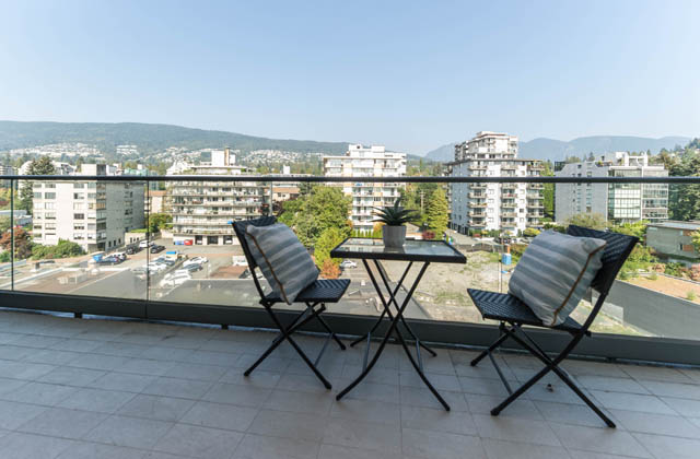 Furnished balcony with city view and outdoor seating. - 601 - 1355 Bellevue Ave, West Vancouver