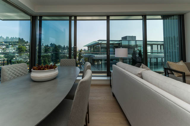 Spacious living room with city view and modern furnishings. - 601 - 1355 Bellevue Ave, West Vancouver