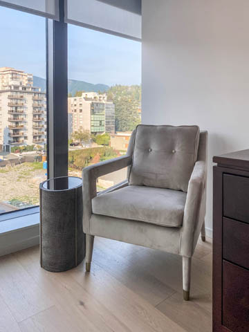 Bright living room with city view and modern furniture. - 601 - 1355 Bellevue Ave, West Vancouver