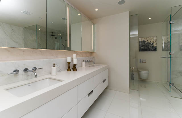 Bright bathroom with marble countertops and a walk-in shower. - 601 - 1355 Bellevue Ave, West Vancouver