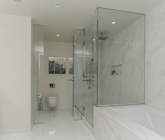 Spacious bathroom with marble countertops and glass shower enclosure. - 601 - 1355 Bellevue Ave, West Vancouver