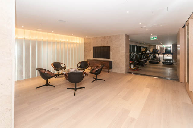 Spacious living room with modern furniture and hardwood floors. - 601 - 1355 Bellevue Ave, West Vancouver