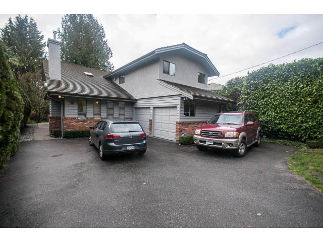 Furnished 4-bedroom house with a spacious driveway and a brick wall. - 4428 Marine Drive, West Vancouver