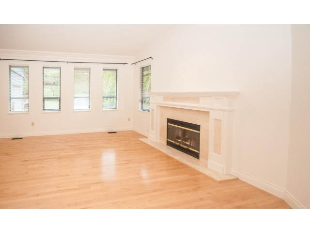 Bright living room with hardwood floors and a fireplace. - 4428 Marine Drive, West Vancouver