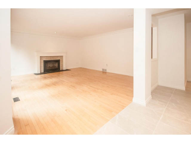 Spacious living room with hardwood floors and a fireplace. - 4428 Marine Drive, West Vancouver