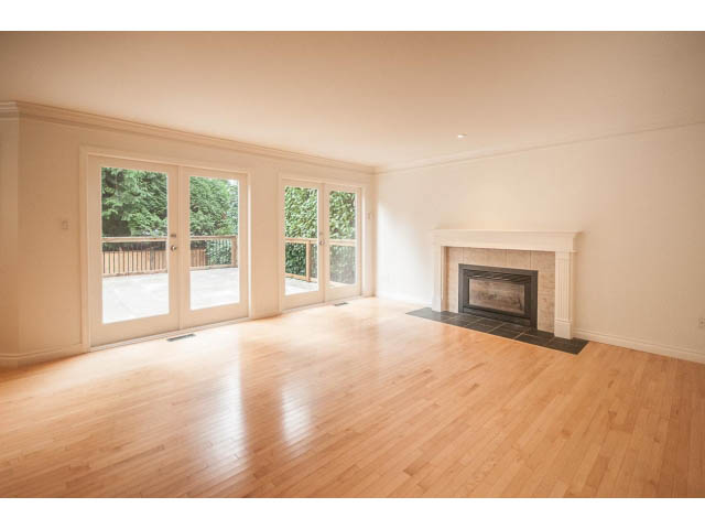 Spacious living room with hardwood floors and large windows. - 4428 Marine Drive, West Vancouver