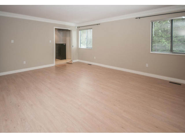 Spacious living room with hardwood floors and large windows. - 4428 Marine Drive, West Vancouver