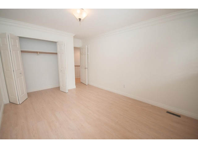 Bright living room with hardwood floors and white walls. - 4428 Marine Drive, West Vancouver
