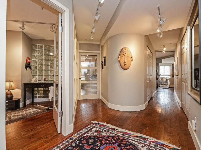 Furnished living area with hardwood floors and a decorative wall mask. - 509 - 1216 Homer Street, Vancouver Downtown