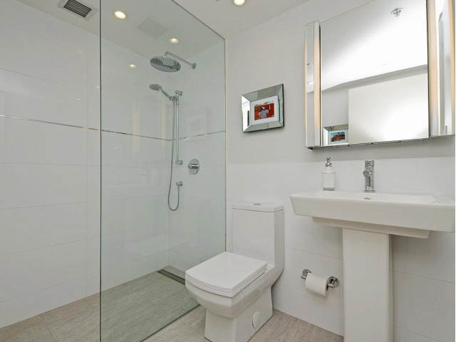 Bright bathroom with white fixtures, glass shower, and countertop sink. - 509 - 1216 Homer Street, Vancouver Downtown