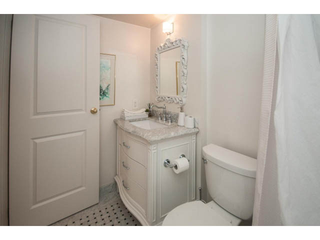 Bright bathroom with white vanity and ornate mirror, clean and inviting. - 1406 - 1060 Alberni Street, Vancouver Downtown