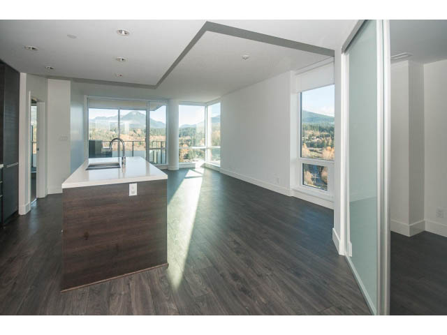 Bright kitchen with wooden countertops and hardwood floors, showcasing a stunning city view. - 2401 - 1550 Fern Street, North Vancouver