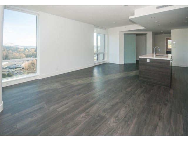 Bright living room with hardwood floors and city view. - 2401 - 1550 Fern Street, North Vancouver