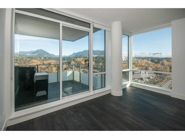 Bright living room with hardwood floors and a stunning city view. - 2401 - 1550 Fern Street, North Vancouver