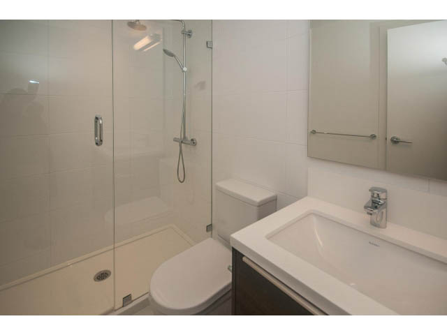 Bright bathroom with white countertop and modern shower, clean and tidy. - 2401 - 1550 Fern Street, North Vancouver
