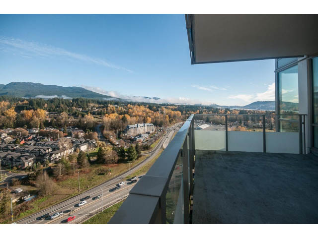Bright living room with city view and modern balcony, overlooking mountains and highway. - 2401 - 1550 Fern Street, North Vancouver