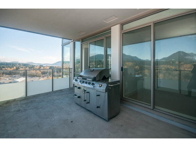 Furnished balcony with outdoor kitchen and panoramic mountain view. - 2401 - 1550 Fern Street, North Vancouver